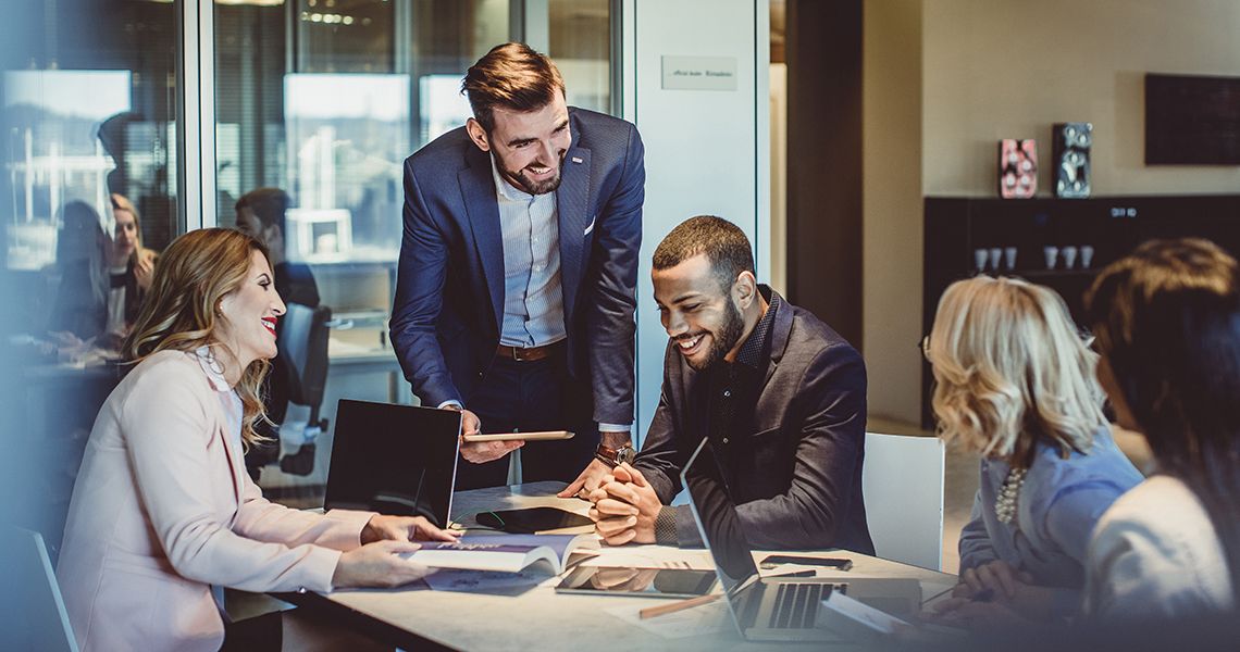 people in business attire in a meeting together