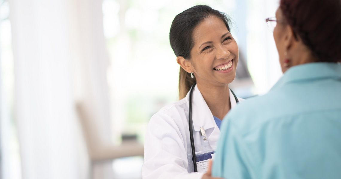 A female physician speaks to another woman