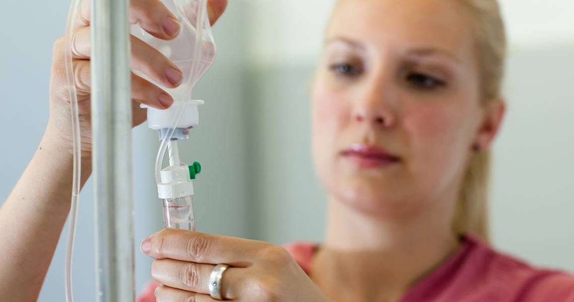 Nurse checking a drip line